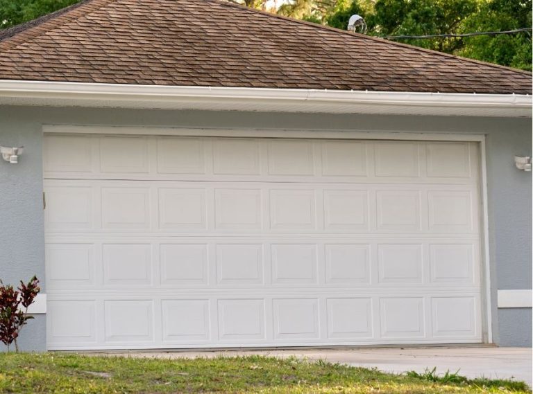 Garage door exterior on a sunny Sacramento day with wind suggesting Delta Breeze conditions